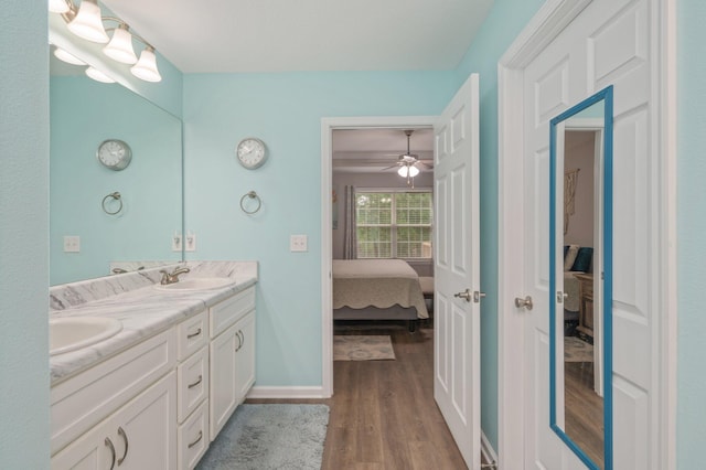 41 S Hidden Lakes Trl, Defuniak Springs, FL 32433 - ensuite bathroom with wood finished floors, double vanity, and baseboards