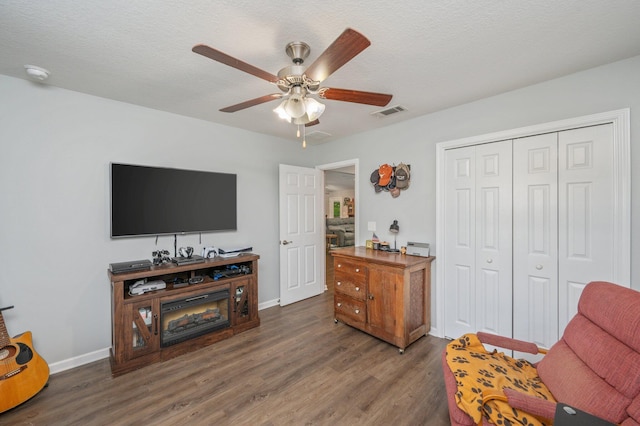 41 S Hidden Lakes Trl, Defuniak Springs, FL 32433 - sitting room featuring a ceiling fan, dark wood-style floors, baseboards, and a textured ceiling