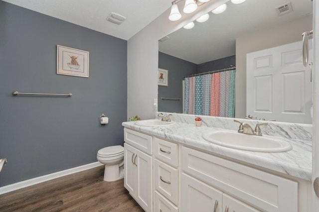 41 S Hidden Lakes Trl, Defuniak Springs, FL 32433 - bathroom with toilet, double vanity, baseboards, wood finished floors, and a shower with shower curtain