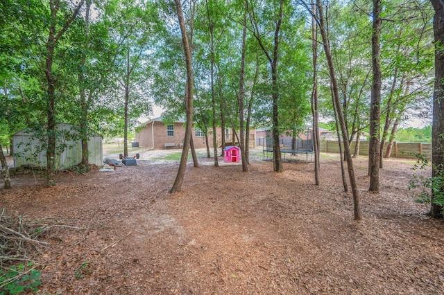 41 S Hidden Lakes Trl, Defuniak Springs, FL 32433 - view of yard with fence, an outdoor structure, and a storage unit