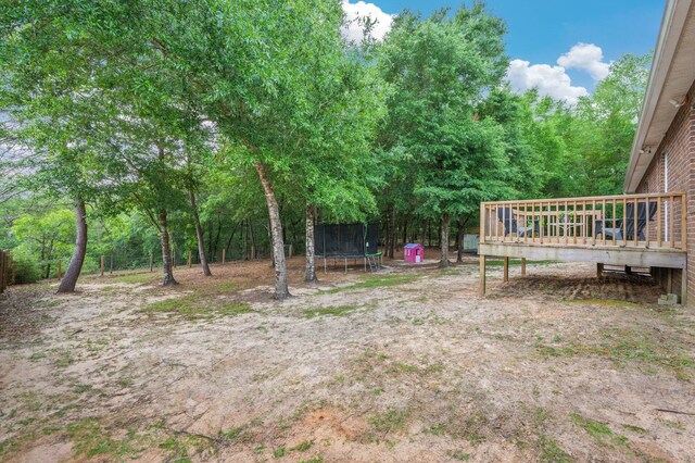 41 S Hidden Lakes Trl, Defuniak Springs, FL 32433 - view of yard featuring a trampoline and a deck