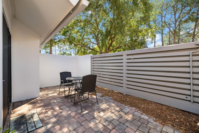 5144 Beachwalk Cir, Miramar Beach, FL 32550 - view of patio / terrace featuring outdoor dining space and a fenced backyard