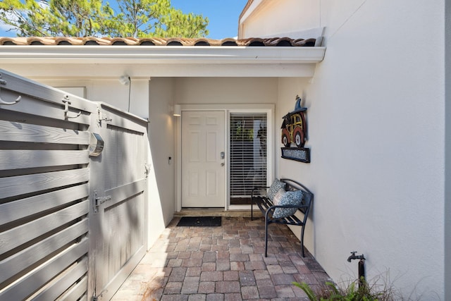 5144 Beachwalk Cir, Miramar Beach, FL 32550 - doorway to property featuring stucco siding and a tile roof