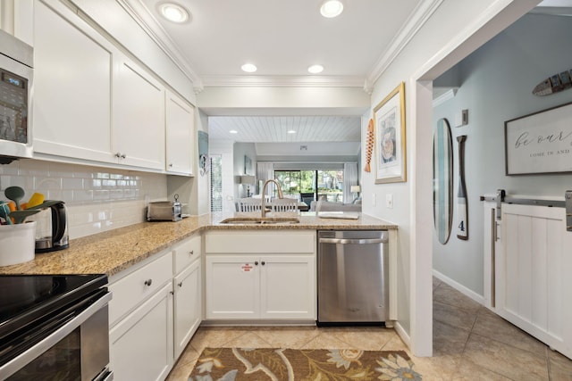 5144 Beachwalk Cir, Miramar Beach, FL 32550 - kitchen featuring appliances with stainless steel finishes, a sink, white cabinets, backsplash, and light tile patterned flooring