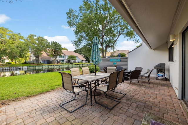 5144 Beachwalk Cir, Miramar Beach, FL 32550 - view of patio / terrace featuring outdoor dining space, a water view, and grilling area