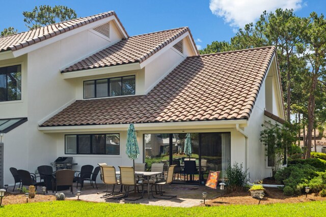 5144 Beachwalk Cir, Miramar Beach, FL 32550 - rear view of property with a tile roof, stucco siding, and a patio