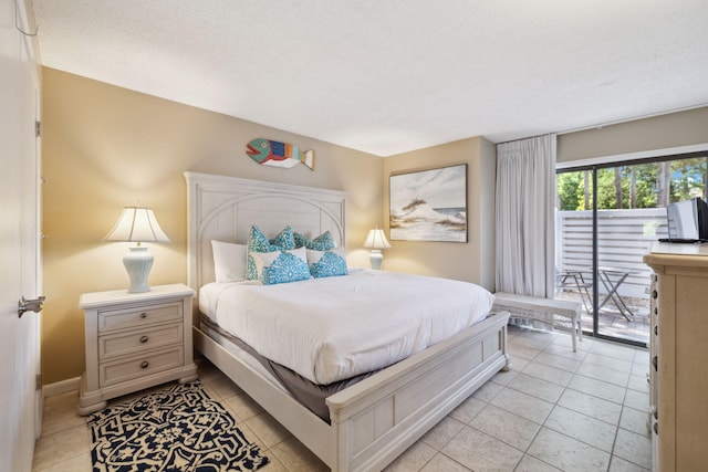 5144 Beachwalk Cir, Miramar Beach, FL 32550 - bedroom featuring access to exterior, light tile patterned floors, and baseboards