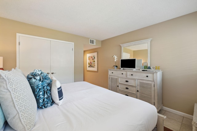 5144 Beachwalk Cir, Miramar Beach, FL 32550 - bedroom with light tile patterned floors, a closet, and baseboards