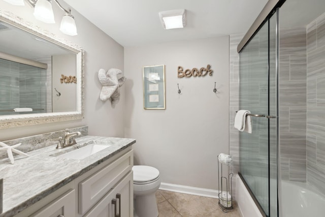 5144 Beachwalk Cir, Miramar Beach, FL 32550 - full bathroom with tile patterned floors, vanity, toilet, bath / shower combo with glass door, and baseboards