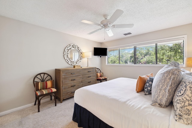 5144 Beachwalk Cir, Miramar Beach, FL 32550 - bedroom with light colored carpet, a textured ceiling, ceiling fan, and baseboards