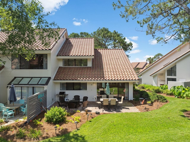 5144 Beachwalk Cir, Miramar Beach, FL 32550 - back of house featuring a yard, a tile roof, a patio, and stucco siding
