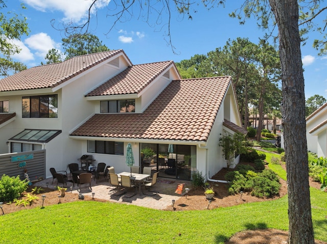 5144 Beachwalk Cir, Miramar Beach, FL 32550 - back of house featuring a tiled roof, stucco siding, and a lawn
