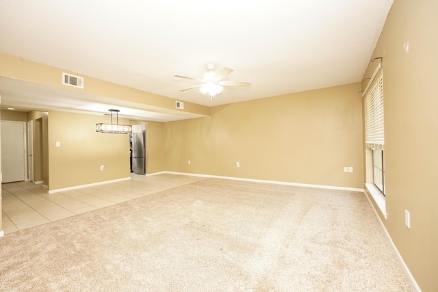 118 5th Ave Unit 118, Shalimar, FL 32579 - spare room with light colored carpet, light tile patterned floors, baseboards, and a ceiling fan
