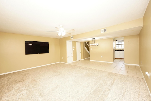 118 5th Ave Unit 118, Shalimar, FL 32579 - unfurnished living room with light carpet, light tile patterned flooring, stairs, and baseboards