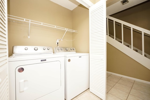 118 5th Ave Unit 118, Shalimar, FL 32579 - laundry room featuring washer and clothes dryer, light tile patterned floors, and baseboards