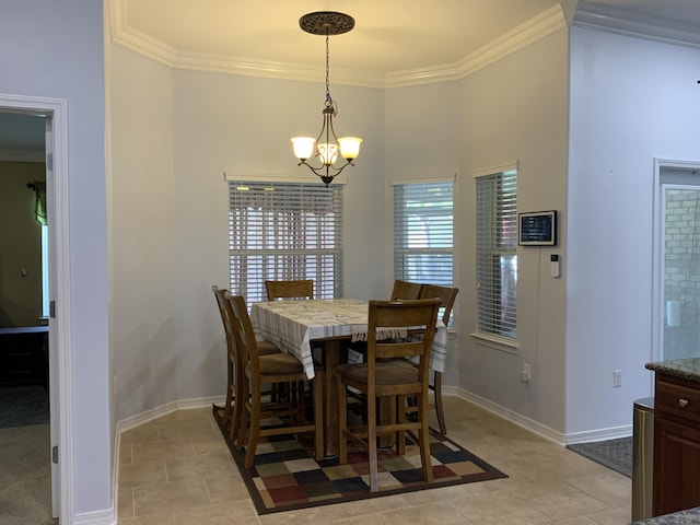 dining room with a chandelier, ornamental molding, baseboards, and light tile patterned flooring