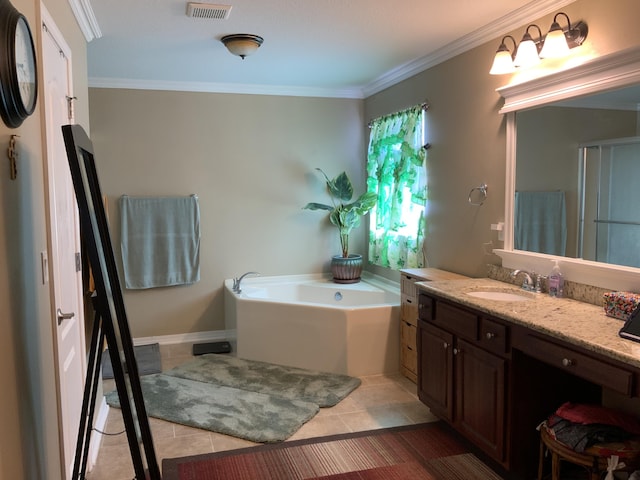 bathroom with a bath, vanity, crown molding, and tile patterned flooring