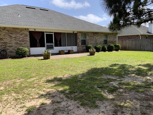 back of property with roof with shingles and brick siding
