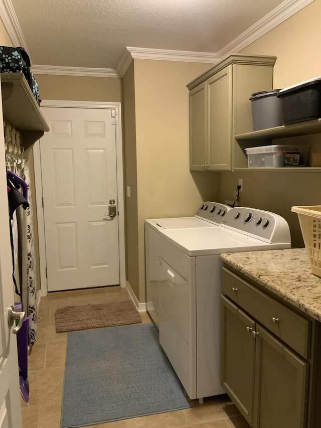 laundry room with washing machine and clothes dryer, cabinet space, ornamental molding, light tile patterned flooring, and baseboards