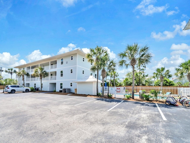 11 Beachside Dr Unit 1211, Santa Rosa Beach, FL 32459 - view of building exterior with uncovered parking and fence