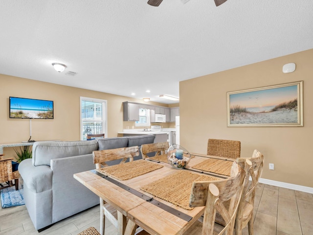 11 Beachside Dr Unit 1211, Santa Rosa Beach, FL 32459 - dining space featuring a textured ceiling, ceiling fan, and baseboards