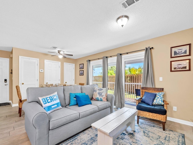 11 Beachside Dr Unit 1211, Santa Rosa Beach, FL 32459 - living area featuring a ceiling fan, baseboards, a textured ceiling, and light wood-style flooring
