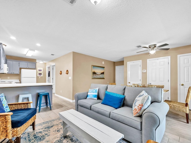 11 Beachside Dr Unit 1211, Santa Rosa Beach, FL 32459 - living room with a ceiling fan, baseboards, recessed lighting, light wood finished floors, and a textured ceiling