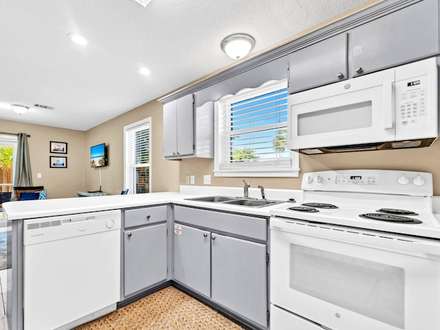11 Beachside Dr Unit 1211, Santa Rosa Beach, FL 32459 - kitchen featuring white appliances, a peninsula, a sink, plenty of natural light, and recessed lighting