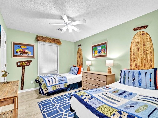 11 Beachside Dr Unit 1211, Santa Rosa Beach, FL 32459 - bedroom featuring wood finished floors, a textured ceiling, a ceiling fan, and baseboards