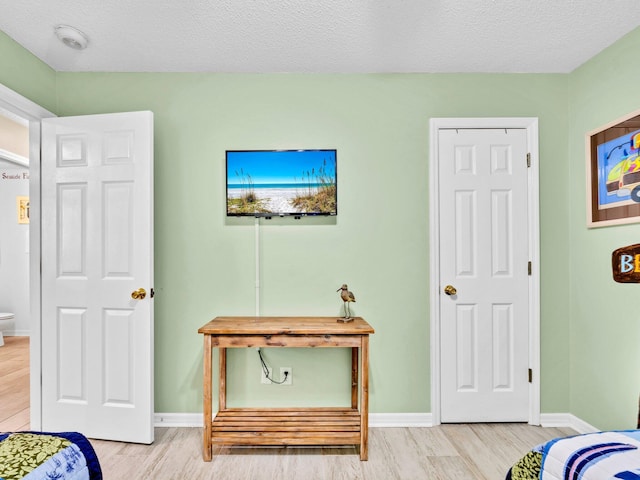 11 Beachside Dr Unit 1211, Santa Rosa Beach, FL 32459 - bedroom featuring wood finished floors, baseboards, and a textured ceiling