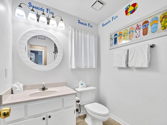 11 Beachside Dr Unit 1211, Santa Rosa Beach, FL 32459 - bathroom with a textured ceiling, toilet, vanity, baseboards, and tile patterned flooring