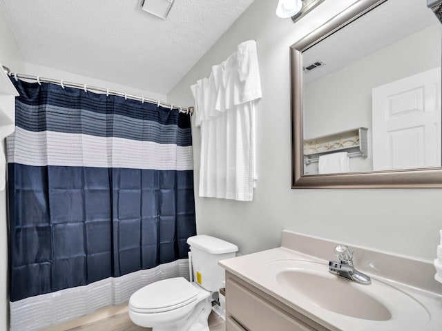 11 Beachside Dr Unit 1211, Santa Rosa Beach, FL 32459 - bathroom with a textured ceiling, toilet, vanity, and a shower with curtain
