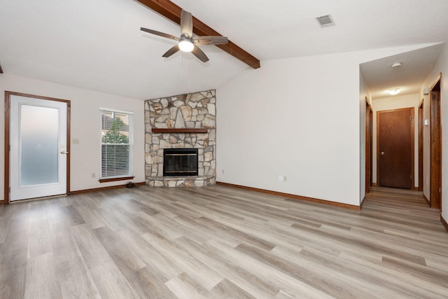 136 Midland Ct, Niceville, FL 32578 - unfurnished living room with a ceiling fan, light wood-type flooring, a stone fireplace, and baseboards
