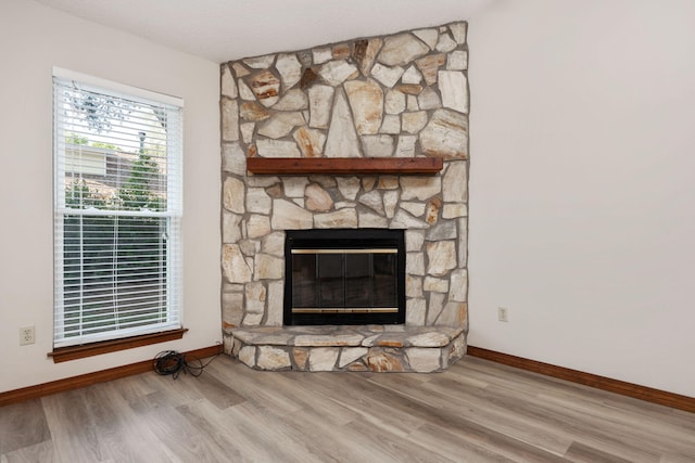 136 Midland Ct, Niceville, FL 32578 - detailed view of baseboards, wood finished floors, and a stone fireplace