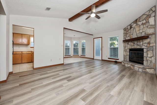 136 Midland Ct, Niceville, FL 32578 - unfurnished living room featuring a ceiling fan, a fireplace, light wood-style floors, baseboards, and a textured ceiling