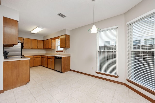 136 Midland Ct, Niceville, FL 32578 - kitchen featuring dishwasher, light countertops, a sink, brown cabinets, and fridge
