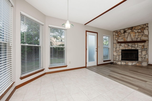 136 Midland Ct, Niceville, FL 32578 - unfurnished living room with baseboards, a fireplace, and light wood-style floors