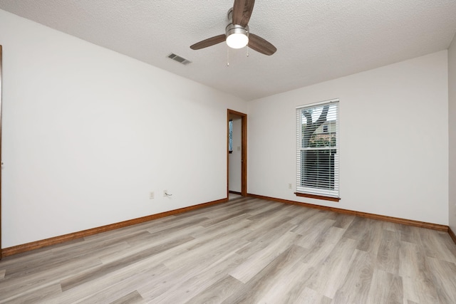 136 Midland Ct, Niceville, FL 32578 - unfurnished room featuring light wood-style floors, baseboards, ceiling fan, and a textured ceiling