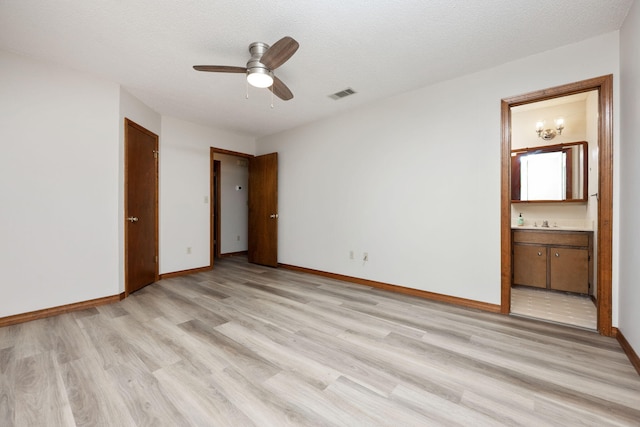 136 Midland Ct, Niceville, FL 32578 - unfurnished bedroom with light wood-type flooring, ensuite bathroom, baseboards, a sink, and a ceiling fan