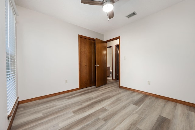 136 Midland Ct, Niceville, FL 32578 - unfurnished bedroom with light wood-style flooring, baseboards, a closet, and ceiling fan