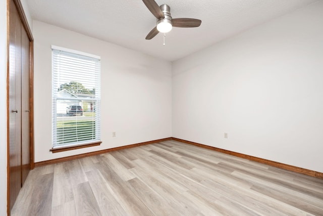 136 Midland Ct, Niceville, FL 32578 - empty room with light wood-type flooring, baseboards, a ceiling fan, and a textured ceiling