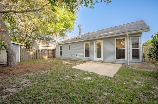 136 Midland Ct, Niceville, FL 32578 - back of house featuring a patio and a shingled roof