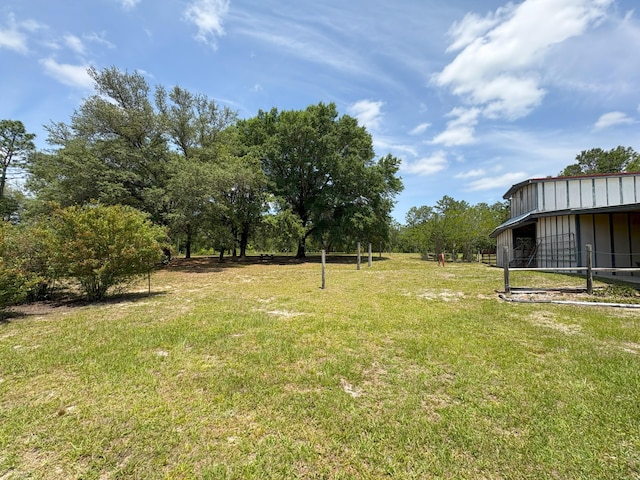 3864 Bear Head Rd, Crestview, FL 32539 - view of grassy yard with a pole building and an outbuilding