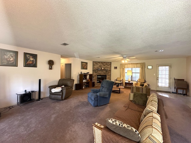 3864 Bear Head Rd, Crestview, FL 32539 - living area featuring a textured ceiling, carpet floors, ceiling fan, and a fireplace