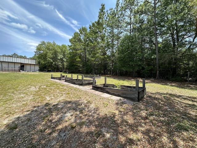 3864 Bear Head Rd, Crestview, FL 32539 - view of grassy yard featuring a garden