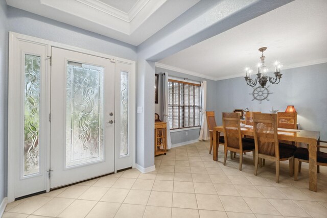 100 Kensington Cir, Panama City Beach, FL 32413 - entrance foyer featuring a chandelier, crown molding, plenty of natural light, baseboards, and light tile patterned floors