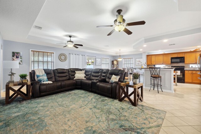 100 Kensington Cir, Panama City Beach, FL 32413 - living room with a tray ceiling, light tile patterned floors, a ceiling fan, and recessed lighting