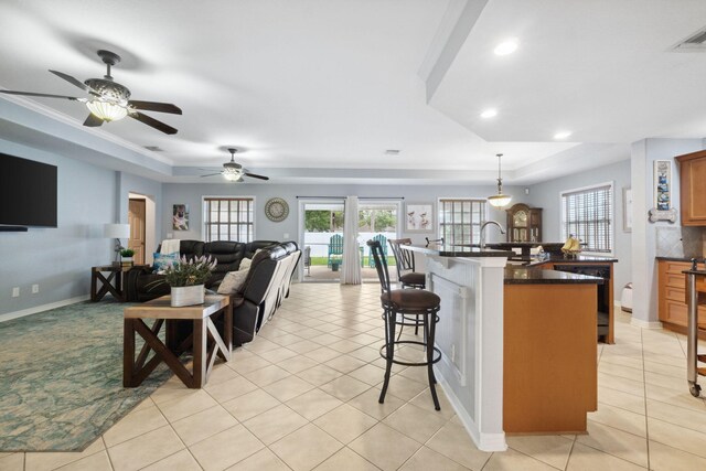100 Kensington Cir, Panama City Beach, FL 32413 - living area with a tray ceiling, light tile patterned floors, recessed lighting, and ornamental molding