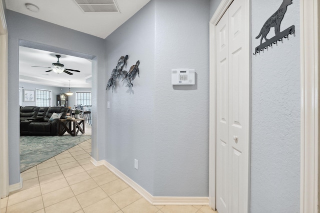 100 Kensington Cir, Panama City Beach, FL 32413 - hallway with tile patterned flooring, baseboards, and a textured wall