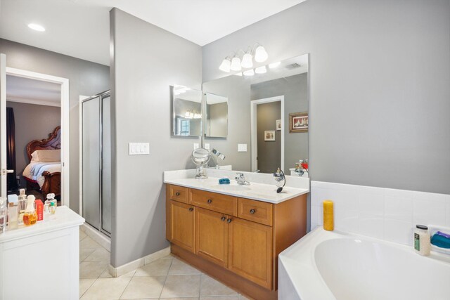 100 Kensington Cir, Panama City Beach, FL 32413 - ensuite bathroom featuring tile patterned floors, a shower stall, vanity, a garden tub, and baseboards
